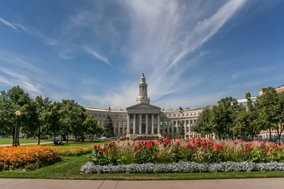 Denver City Hall building with green lawn and red flowers in front, Denver, Colorado